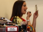 A stamp lies on a table as Sabah Zaib applies Halal certified make-up in Birmingham